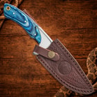 Knife in brown leather sheath on wood