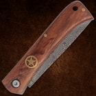 Closed folding knife with wooden handle and star emblem