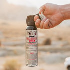 Full image of the 9.2 oz Bear and Mountain Lion Spray held in hand.