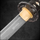 Shinwa katana sword encased in red lacquered saya with dragon emblem extended to white rayskin handle wrapped with black cord
