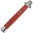 Closed wood handle stilleto pocket knife with button trigger and mirror polished accents.
