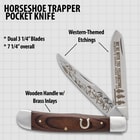 Horseshoe trapper pocket knife with dual blades, western-themed etchings, and wooden handle with brass inlays