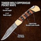 The pocket knife has a Damascus steel blade with filework