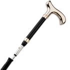Zoomed view of shiny gold handle with blade being expelled from cane

