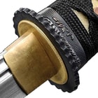 This Kojiro has a hair-splitting sharp, 11” 1045 carbon steel blade, which extends from a polished brass habaki and a black metal alloy guard