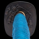 The hardwood handle is wrapped in genuine black rayskin and blue cord and there’s an engraved brass habaki