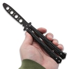 Full image of the Butterfly Trainer open held in hand.