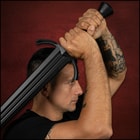A person holding the training broadsword.