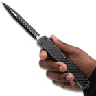 Gray OTF Nightpiercer in hand