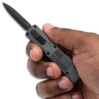 Gray Freedom Strike OTF Knife in hand