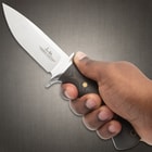 4 5/8" 420HC stainless steel blade with a stain finish and G10 wood look handle, and engraving on blade "Hibben Knives."
