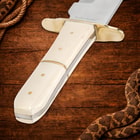Close-up of ivory handle knife on wooden background