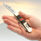 The trapper is shown in someones hand.