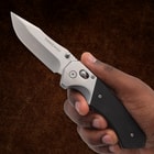 Hand holding a Timber Wolf folding knife