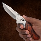 Hand holding Timber Wolf folding knife