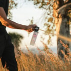 Close up image of the Bear & Mountain Lion Spray held in hand being sprayed.