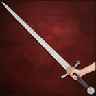 Angled view of the black leather wrapped handle with circular pommel and decorative guard accent.