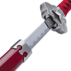 The wooden handle is wrapped in black faux rayskin and red cord with a black cord and bead tassel in the pommel