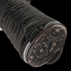 The hardwood handle is wrapped in genuine, white rayskin and black cord and the tsuba is metal alloy in a golden dragon design
