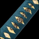 Zoomed view of brass tsuba embossed with double swords on each side showcasing tea dyed rayskin wrapped in a teal cord
