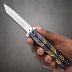 Hand holding butterfly knife with dragon design on handle