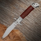 The automatic stiletto on display sticking into a piece of wood