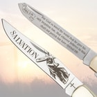 Close-up of pocket knife blades with Christian etchings