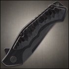 Closed blacked out pocket knife with CNC scalloped G10 inserts and a lanyard hole. 
