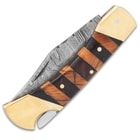 The Timber Wolf Copperhead Pocket Knife has a banded wooden handle