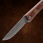 Folding knife with detailed patterned blade and wooden handle
