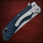 Closed pocket knife with large pocket clip inscribed with "honshu" and a tiedye style blue and black handle. 
