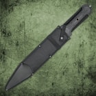 A hand holding the tpr rubberized handle of United Cutlery Combat Commander gladiator 1060 stainless steel sword with a sharp point
