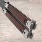 Close-up of butterfly knife's wooden handles and metal details