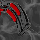 Close-up of butterfly knife handle with red accents