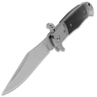 The clip-point blade of the automatic knife prominently displayed