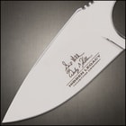 The smooth, black pakkawood handle scales are secured to the tang with heavy-duty stainless steel pins