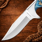 Close-up of knife blade on wooden background