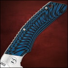 Angled view of extended pocket knife with a shining silver double edged blade and blue and black handle. 
