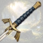 Sword handle with intricate design and brass accents in a forest