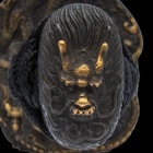 It has an antiqued brass, square tsuba with an intricately detailed Samurai and Chinese dragon design and a pommel to match