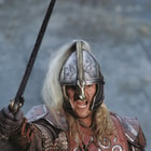 This image shows Eomer wielding his sword and wearing his helm.