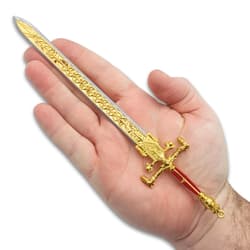 Sword laying on someones hand.