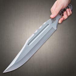 Mirror polished "Gil Hibben" throwing knife imbeded into the bulls-eye of a wooden target.