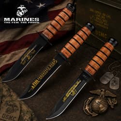 Three USMC knives with engraved blades on a flag background