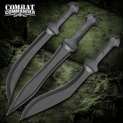 Three black tactical knives with textured handles on a green background