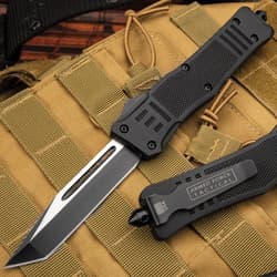 Black tactical knife on tan military gear