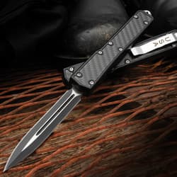 The USA Tactical Black OTF Automatic Knife can be deployed with the slide trigger on the side.