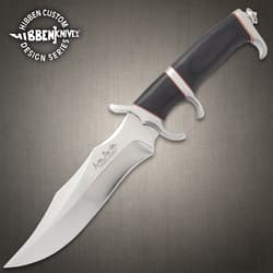 Legacy III fighter knife with black, silver, and red accents on a background of black rocks.