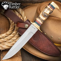 Bowie knife with leather sheath on cowboy hat and rope