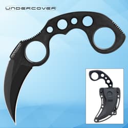 Black karambit knife with sheath on blue background